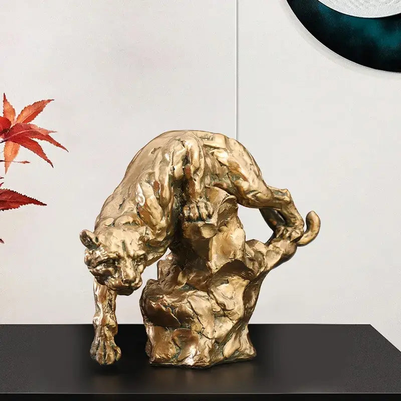 Luxury golden leopard panther figurine with textured rugged surface in dynamic pose for living room decor by decorbites