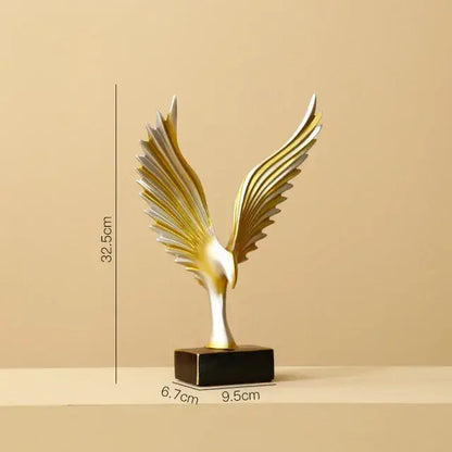 A sleek gold and silver eagle figurine with outstretched wings on a black base for decorbites golden leopard living room decor