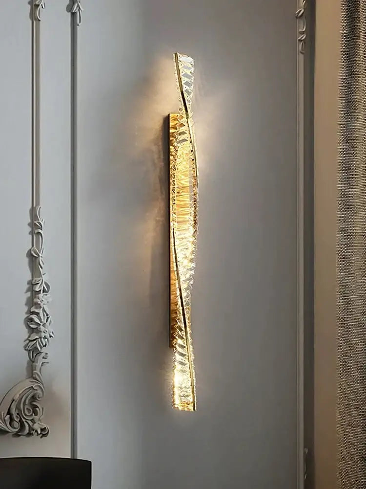 Luxury golden twisted crystal led wall sconce with decorbites crystal led accents emitting warm bedroom light