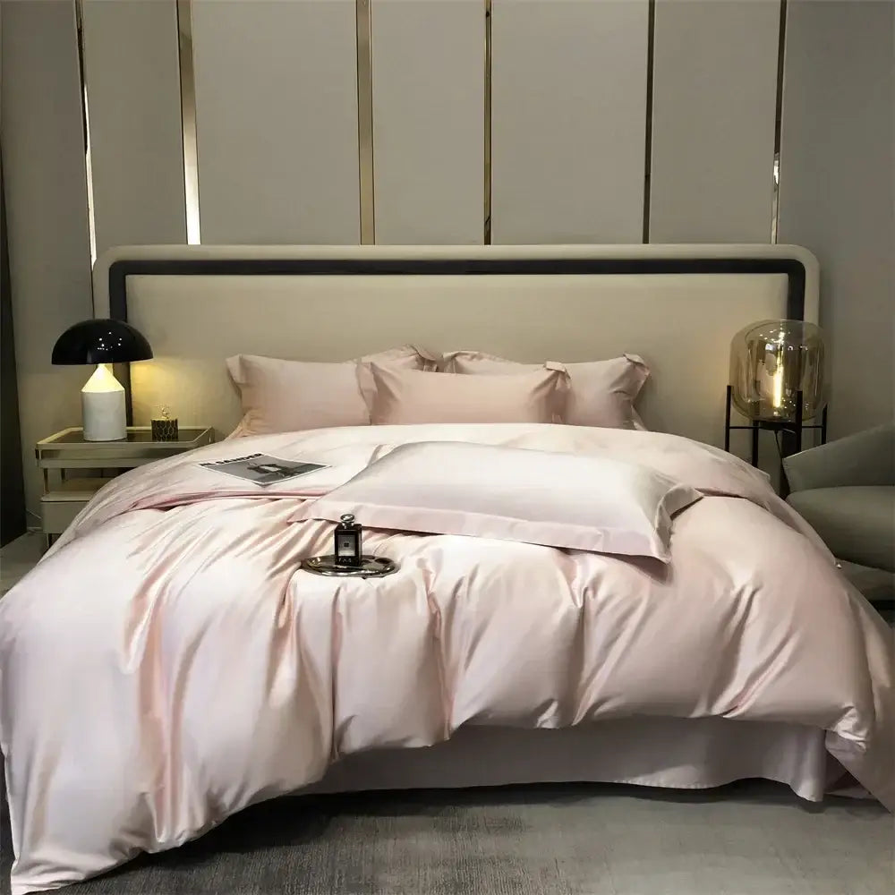 Luxurious blush pink satin duvet bedding set with matching pillowcases featuring a smooth glossy finish and elegant folds