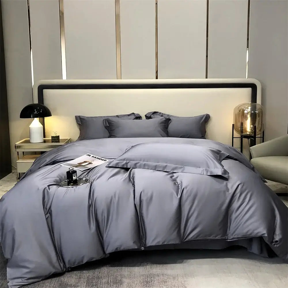Luxury gray egyptian cotton bedding set with satin duvet cover and matching pillows arranged on a modern bed