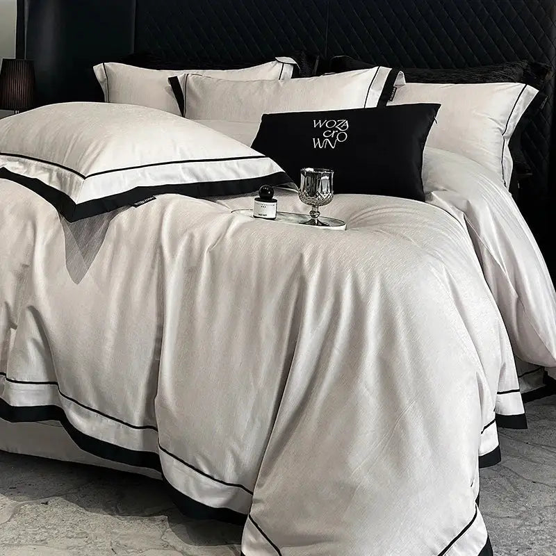 White satin-like bedding set with black piping and an embroidered pillow complementing egyptian cotton leopard jacquard design