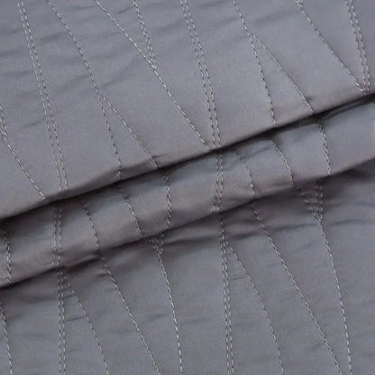 Luxury gray textured egyptian cotton quilt set with subtle diagonal stitching in lighter gray thread for bedroom bedding