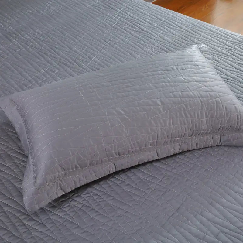 Gray quilted pillow with subtle diagonal stitching from luxury gray textured egyptian cotton quilt set for bedroom bedding