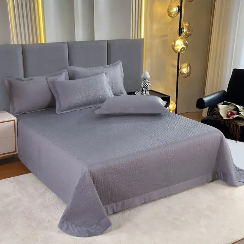 Luxury gray textured egyptian cotton quilt set featuring a subtle crinkle finish draped neatly over the mattress