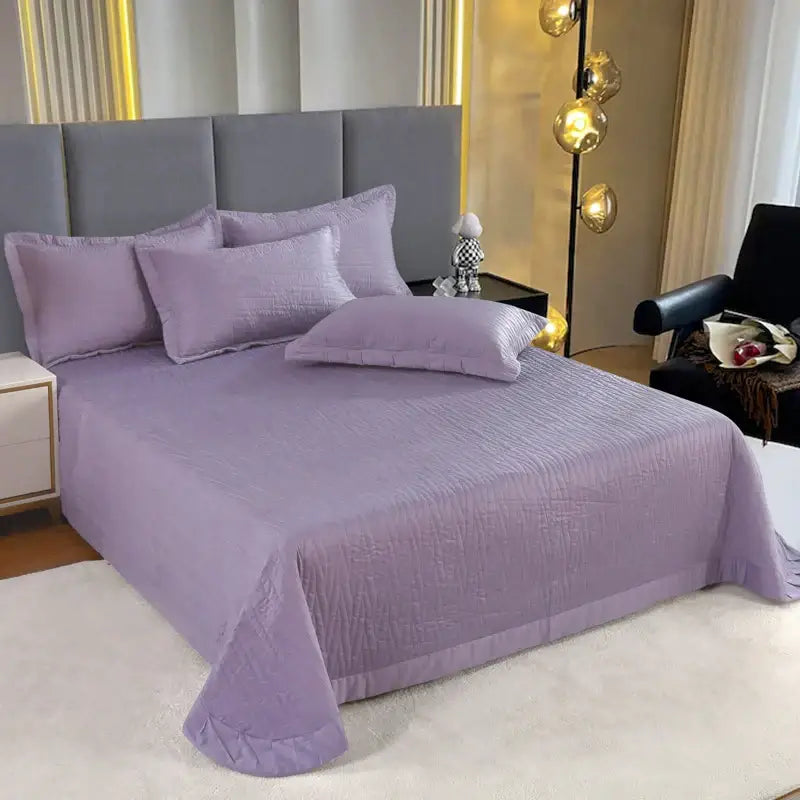 Lavender-colored quilt set featuring a subtle textured pattern and ruffled hem made of egyptian cotton quilt material