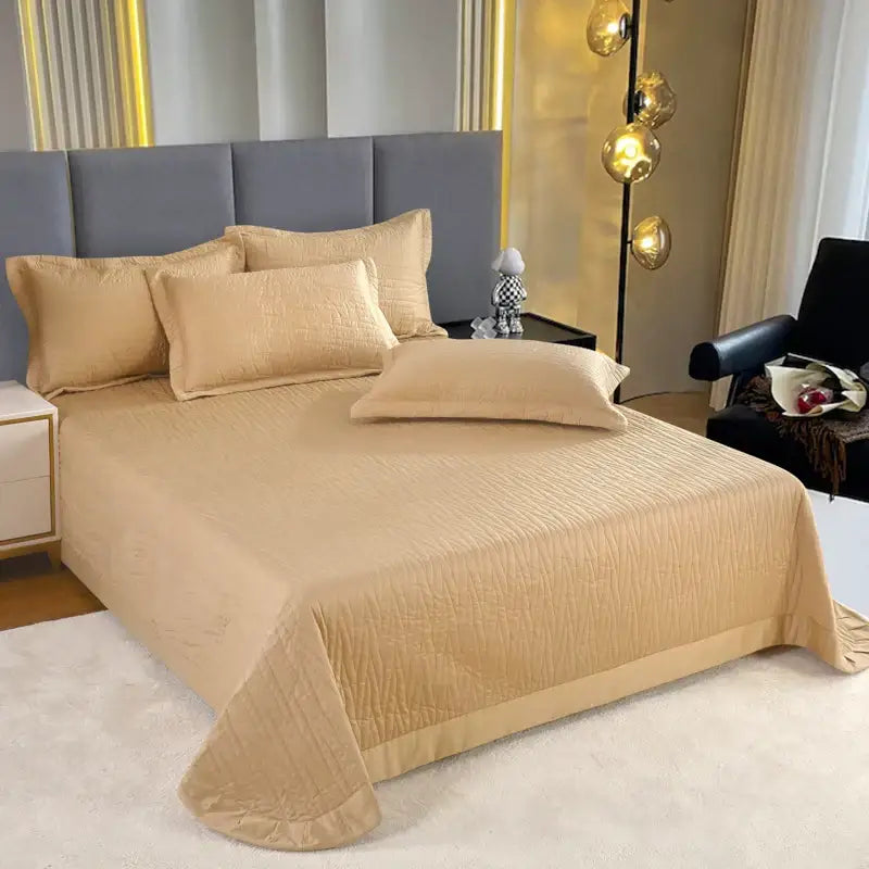 Beige quilted bedspread with subtle texture and ruffled hem from luxury gray textured egyptian cotton quilt set