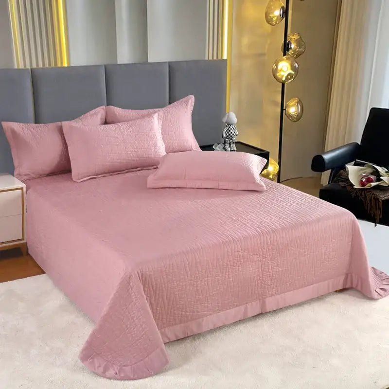 Pink quilted bedspread with ruffled edges in a luxury gray textured egyptian cotton quilt set for bedroom bedding