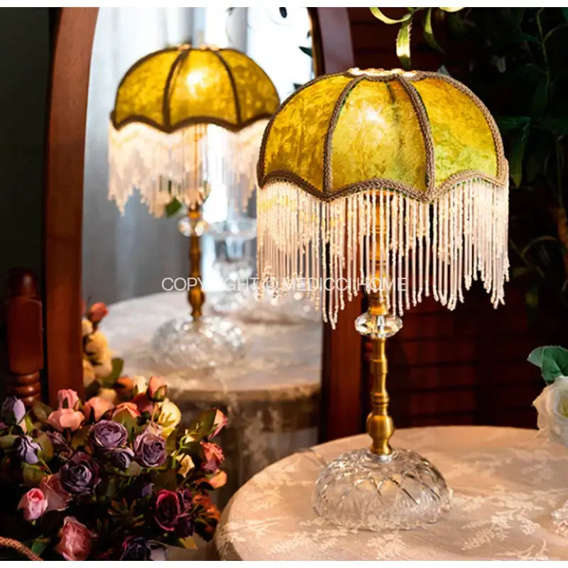 Elegant gold-toned table lamp with yellow patterned glass shade and white beaded fringe for decorbites green velvet tasseling decor