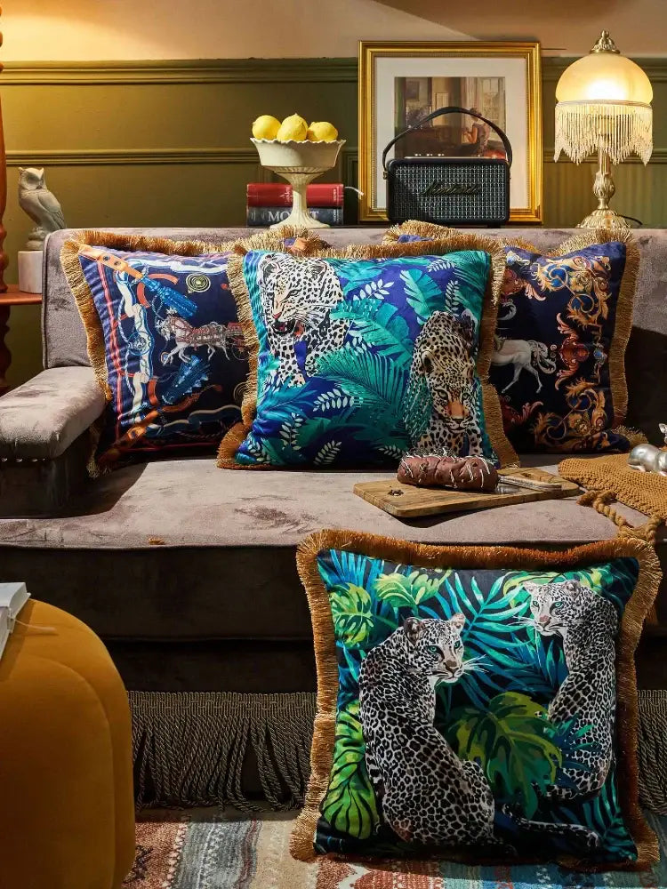 Vibrant blue and green leopard cushion cover with gold fringe from decorbites jungle animal collection for living room decor