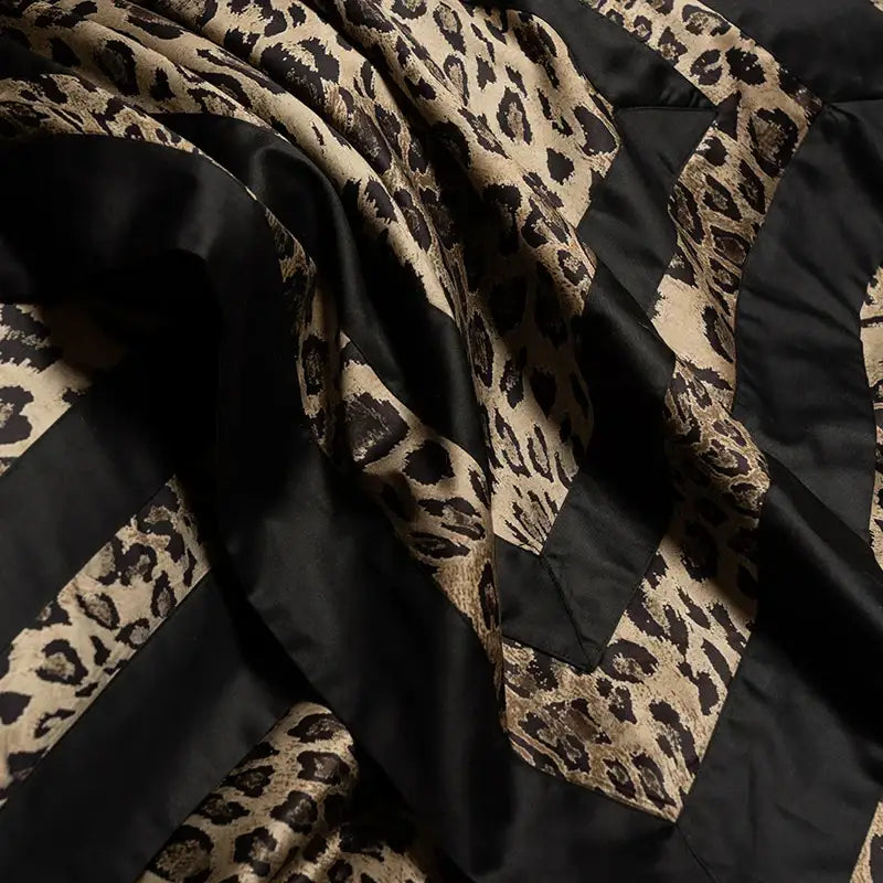 Black and tan leopard print quilted blanket with satin trim in bedding set for decorbites leopard print luxury decor
