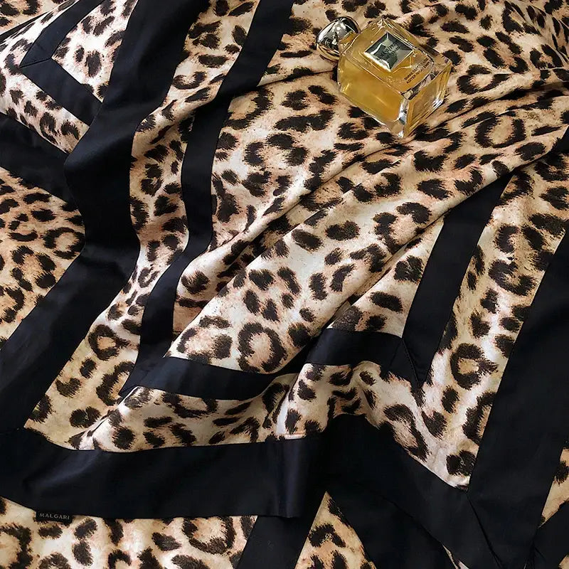 A luxurious leopard print silk scarf with black satin stripes and the Malagari label for decorbites bedding set accent