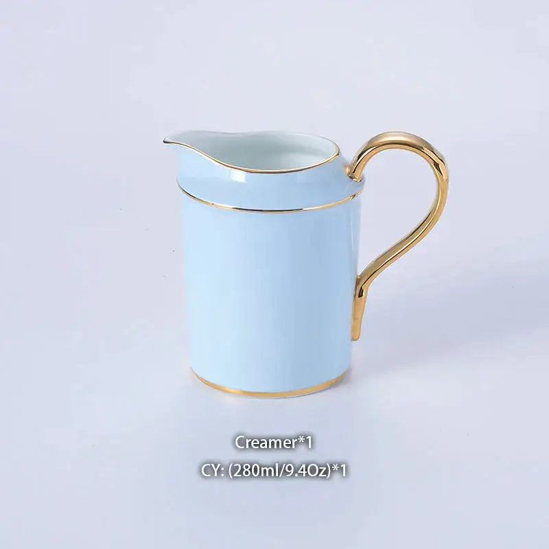 A delicate light blue ceramic creamer with gold trim from the decorbites bone china coffee set for elegant dining
