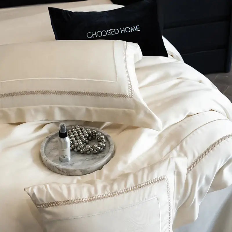 Cream-colored satin pillowcases with silver chain-stitched trim from decorbites light champagne luxury bedding set