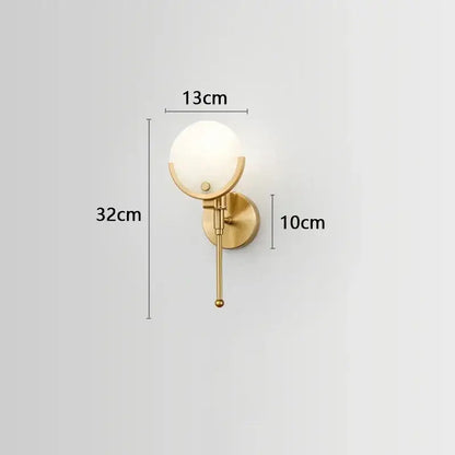Luxury gold-toned copper wall lamp with frosted glass globe and slender stem for elegant bedroom lighting