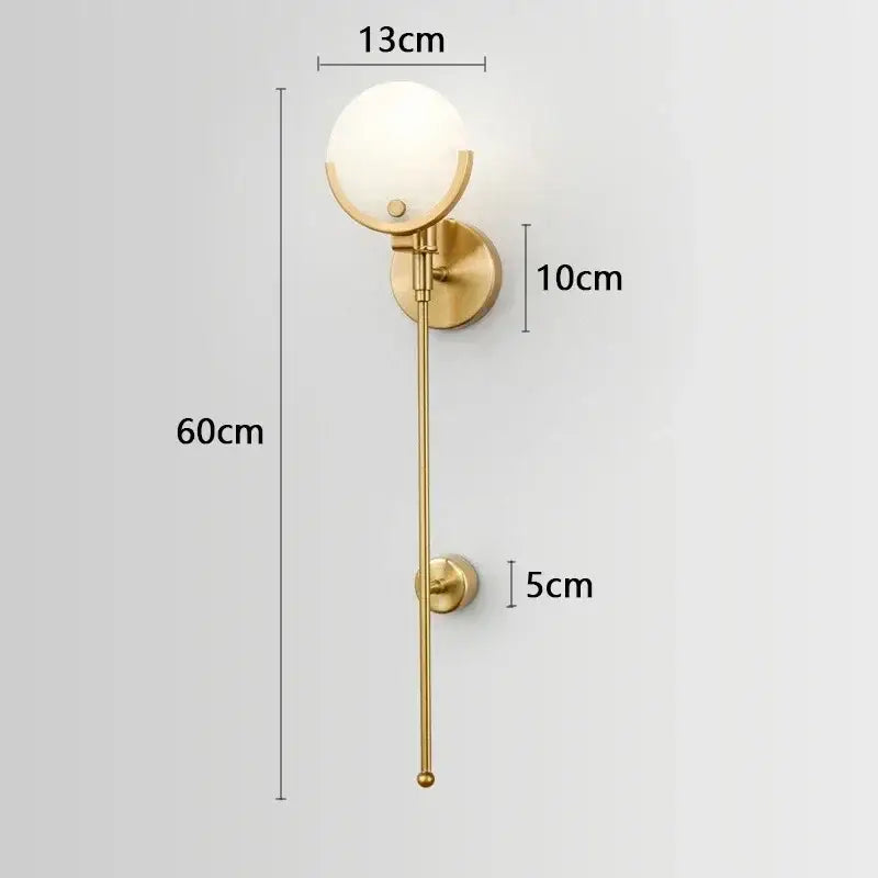 Luxury marble and copper wall lamp featuring a gold-toned copper wall sconce with frosted glass globe and slender rod