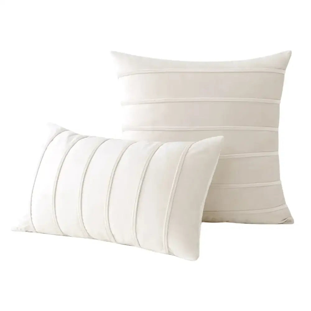 Cream-colored velvet throw pillows with subtle horizontal pleats complement decorbites blue velvet stripe pillow covers