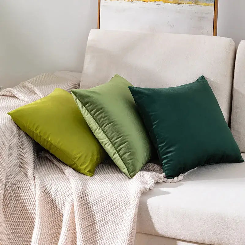 Three square luxury olive green velvet pillow cases resting on a cream sofa for decorbites green velvet pillow decor