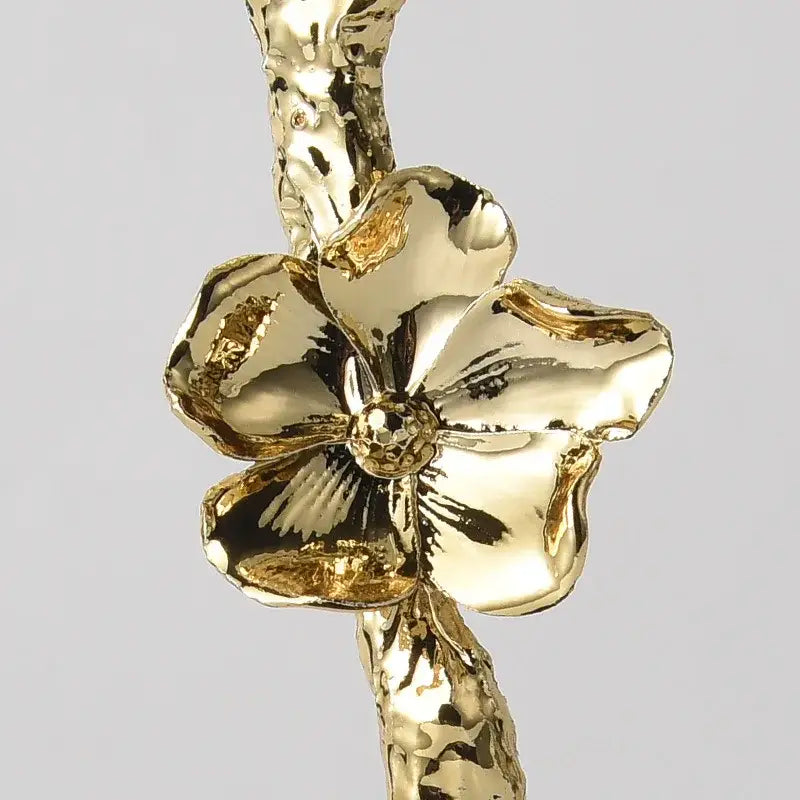Luxury porcelain crystal rose decor featuring a golden hammered flower pendant with intricate petal design