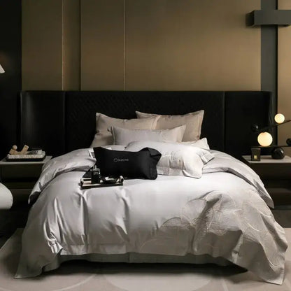 Luxurious silver-gray satin duvet bedding set with subtle embroidered floral patterns and matching pillow sham