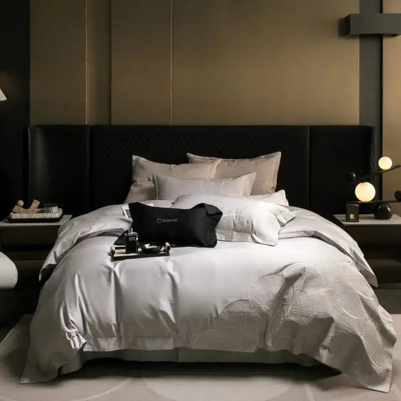 Luxurious silver-gray satin duvet bedding set with subtle embroidered floral patterns and matching pillow sham