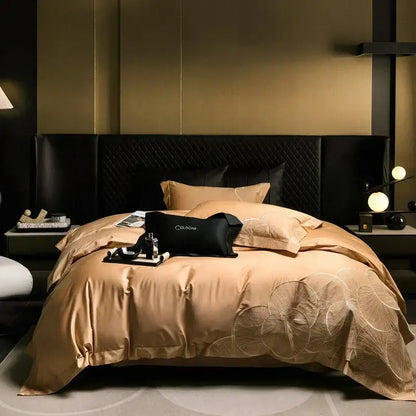 The elegant gold satin cotton bedding set with embroidered leaf pattern and black quilted pillows for luxury bedrooms