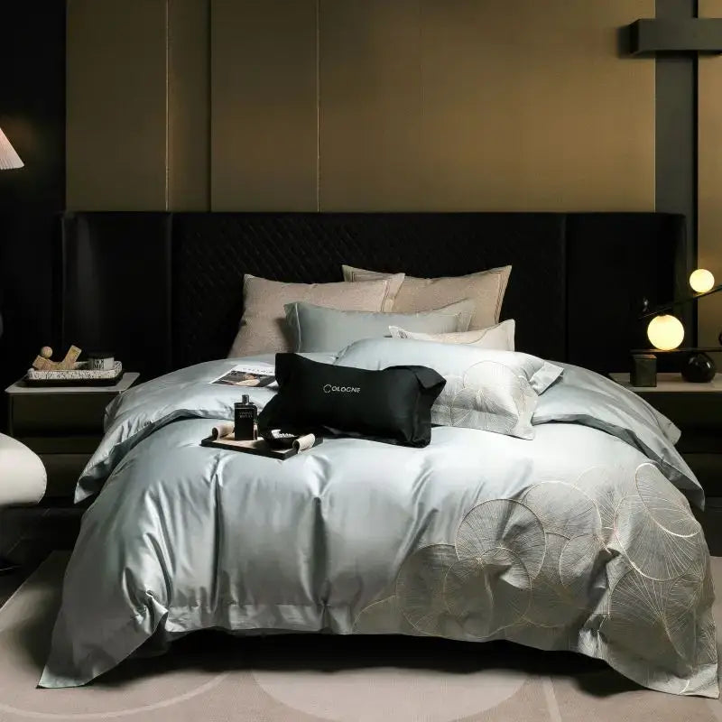 Luxury red and white lotus embroidered cotton bedding set with light blue satin duvet cover featuring subtle circular patterns