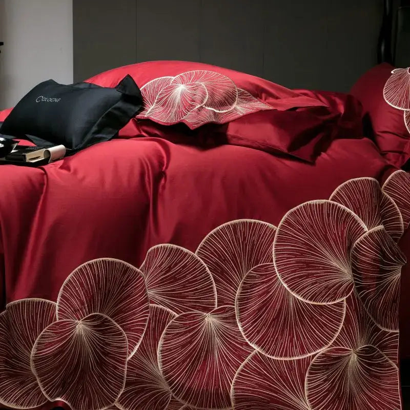 Luxury red and white lotus embroidered cotton bedding set featuring rich crimson satin duvet cover with elegant patterns