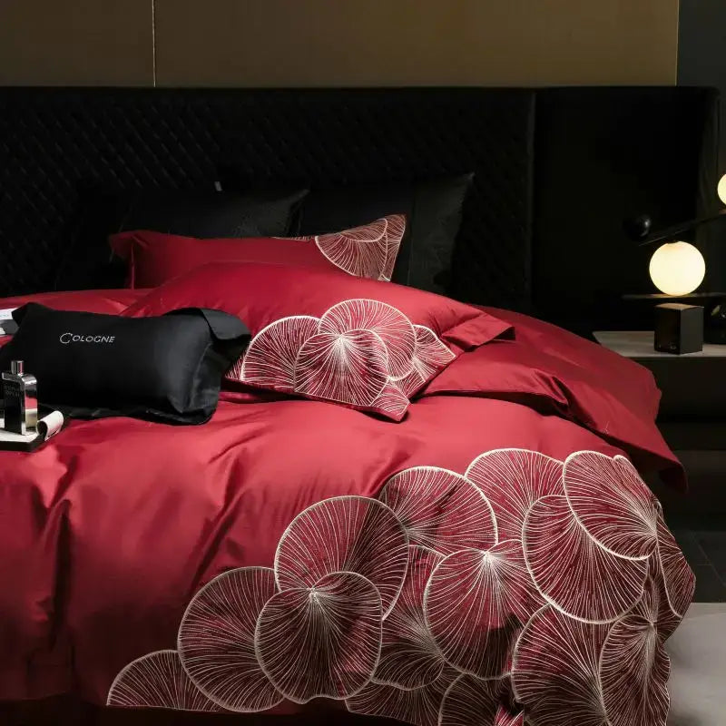 Luxury red satin cotton bedding set with intricate white lotus embroidered ginkgo leaf patterns for bedroom use