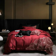 Luxury red satin duvet cover with white embroidered lotus patterns in a cotton bedding set for bedroom use