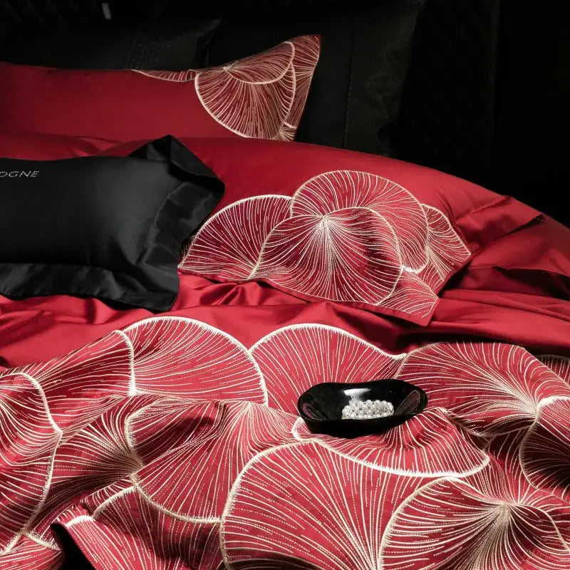 Luxury red cotton bedding set featuring intricate white embroidered ginkgo leaf patterns for elegant bedroom decor