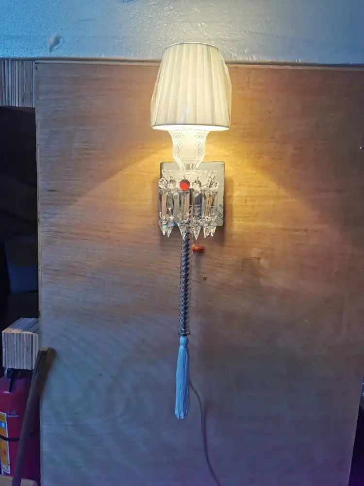 Luxury silver crystal wall lamp with white pleated shade and blue tassel for elegant bedroom decorbites crystal wall lamp