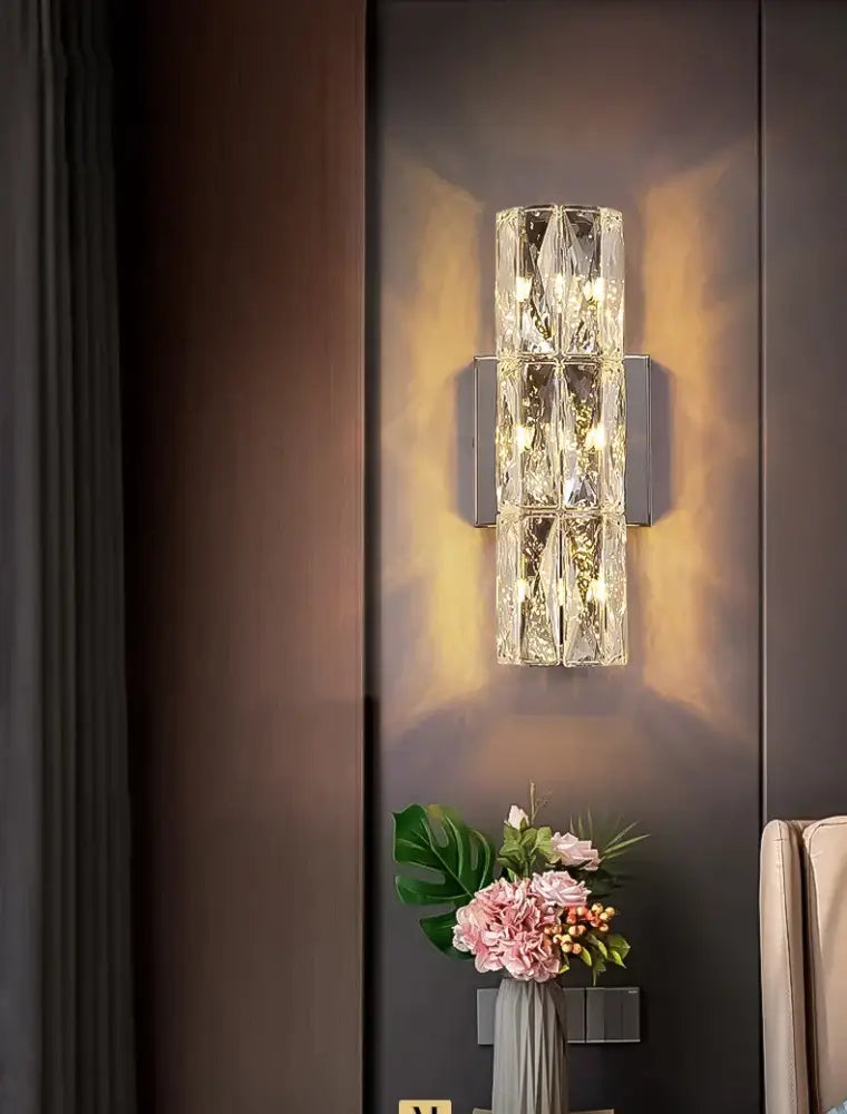 Luxury silver crystal deluxe wall sconce with modern rectangular design and warm ambient lighting for living room decorbites