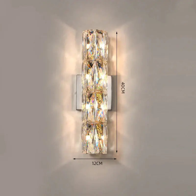 Luxury silver crystal wall sconce with stacked faceted segments refracting warm light for living room decorbites crystal deluxe