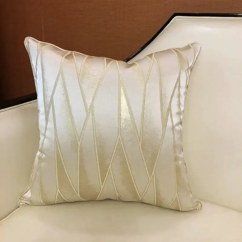 Cream-colored luxury cushion cover with gold-threaded geometric stitching in satin and quilted jacquard fabric