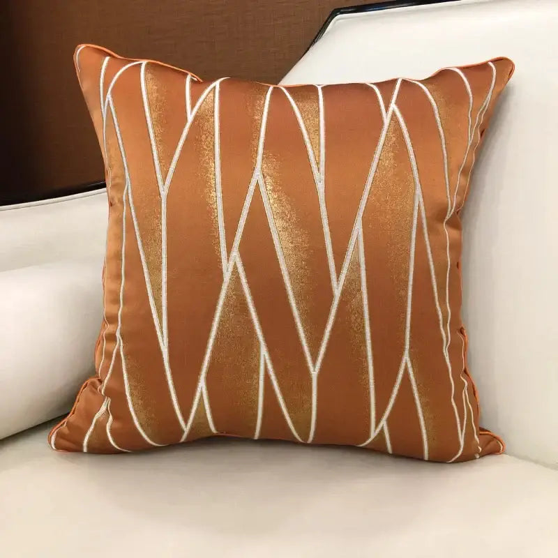 Luxury rust-orange satin cushion cover with shimmering gold and white geometric embroidery for bedroom decor