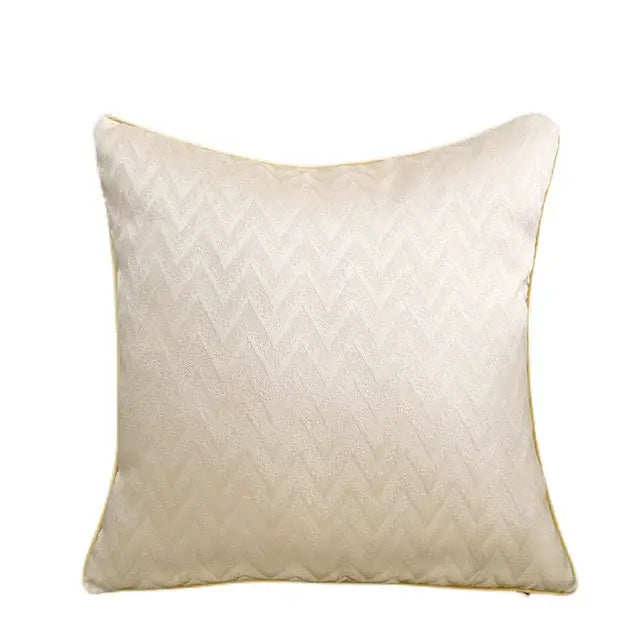 Cream-colored luxury cushion cover with subtle zigzag texture and gold-toned piping for an elegant bedroom decor