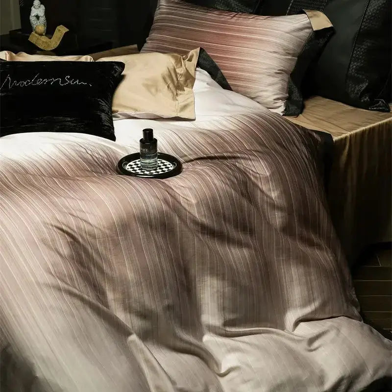 A sleek black perfume bottle on a checkered tray atop bed of luxury taupe and beige striped lyocell cotton bedding set decorbites light luxury
