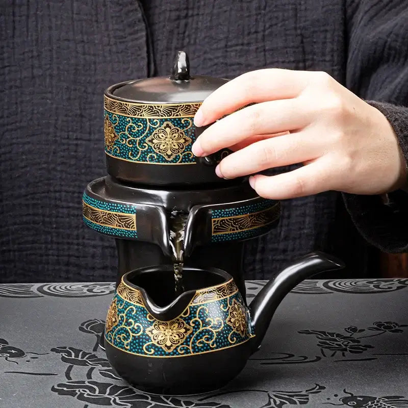 Luxury black ceramic kung fu tea set with turquoise and gold floral patterns and tiered pouring design