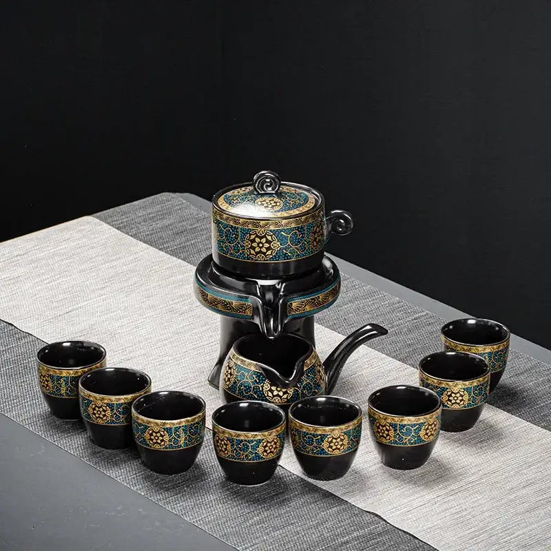 Elegant black ceramic kung fu tea set with turquoise and gold floral patterns featuring teapot and eight cups