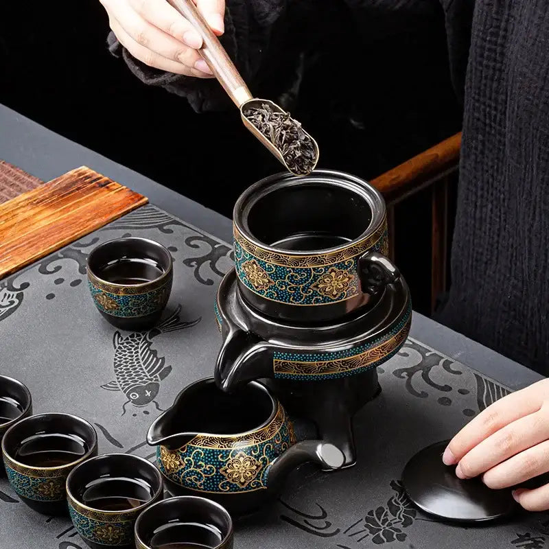 Black ceramic kung fu tea set with intricate turquoise and gold floral patterns for luxury dining room use