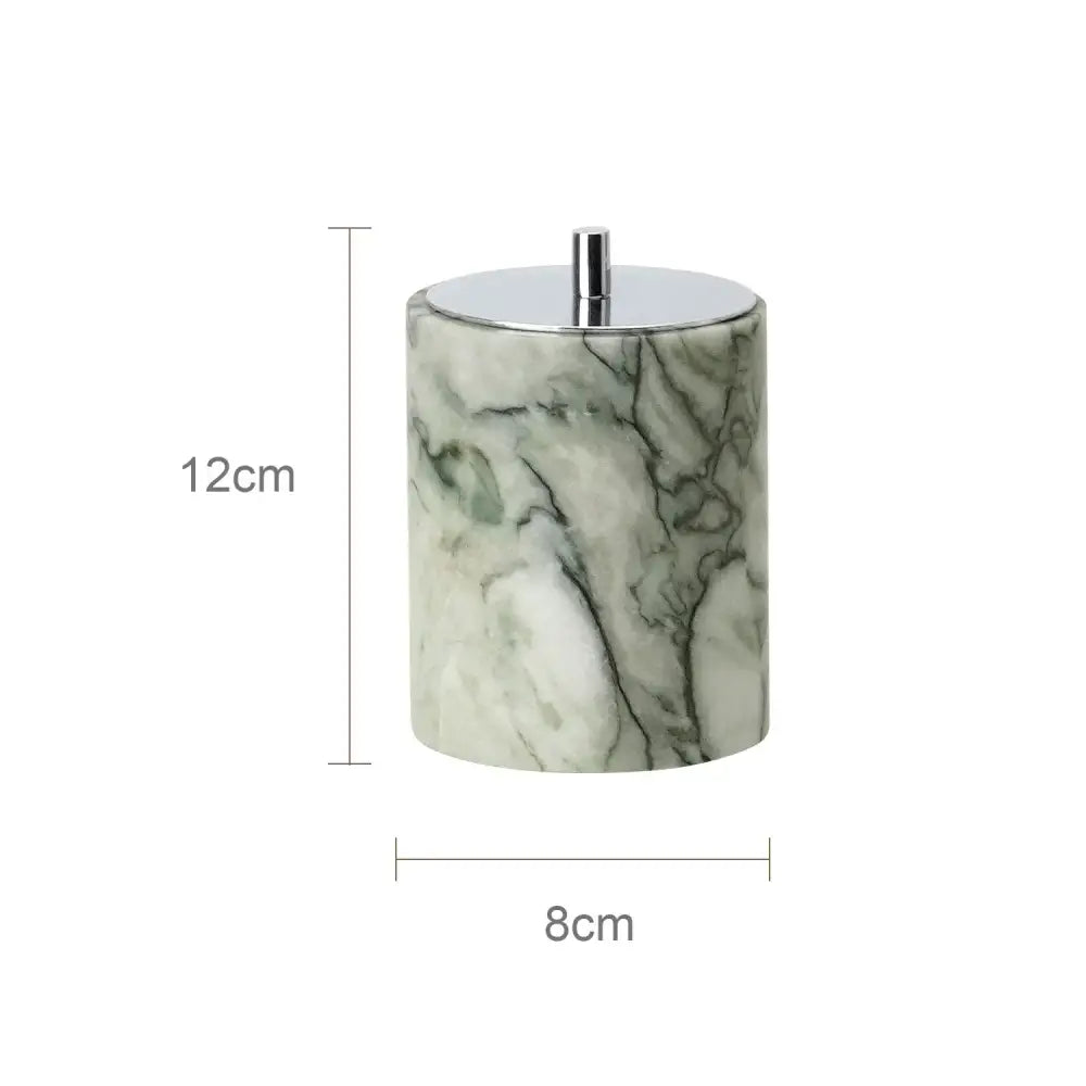 A cylindrical emerald marble container with white accents and silver lid from a luxury marble bathroom set