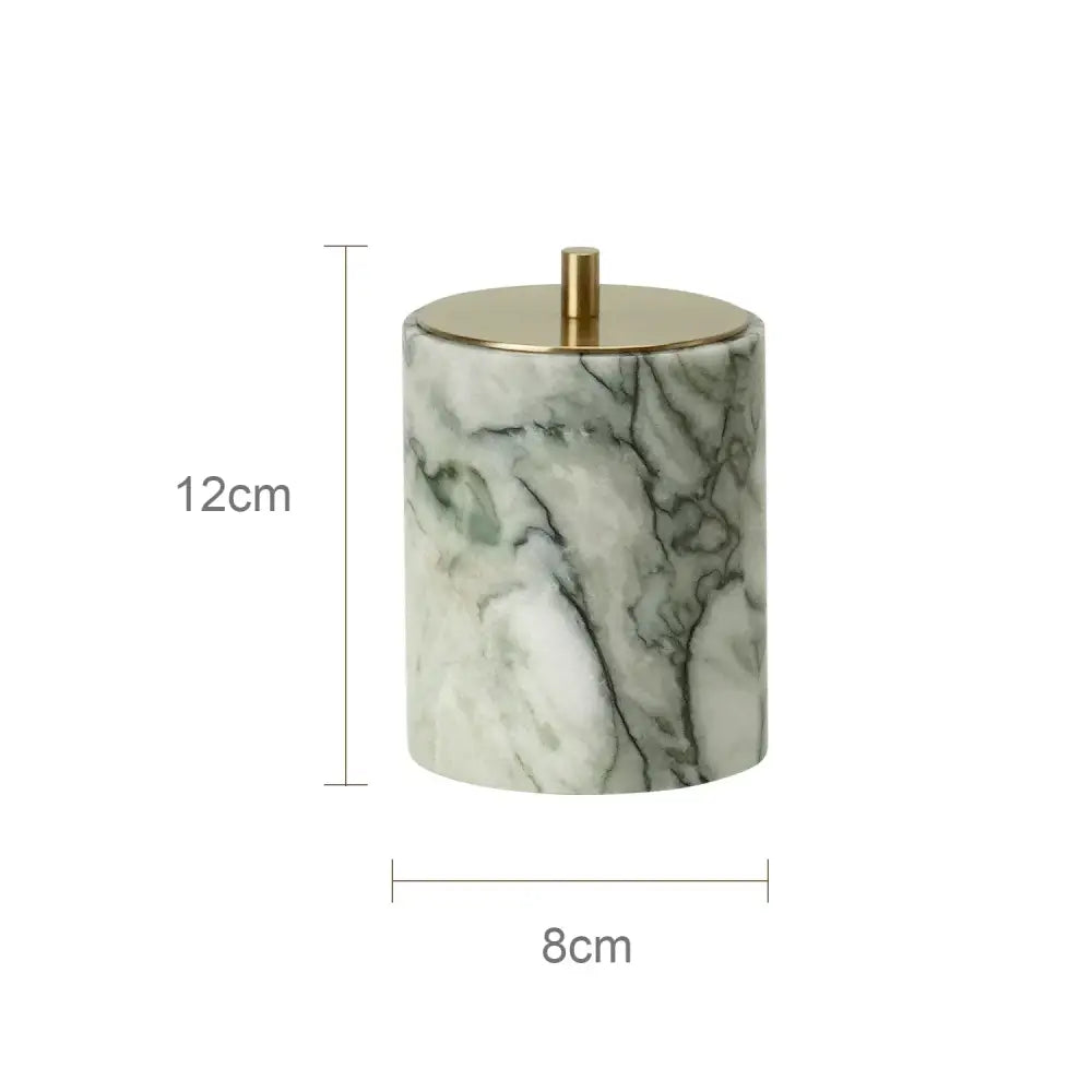 A green and white marble patterned ceramic jar with a gold lid from a luxury emerald marble bathroom set