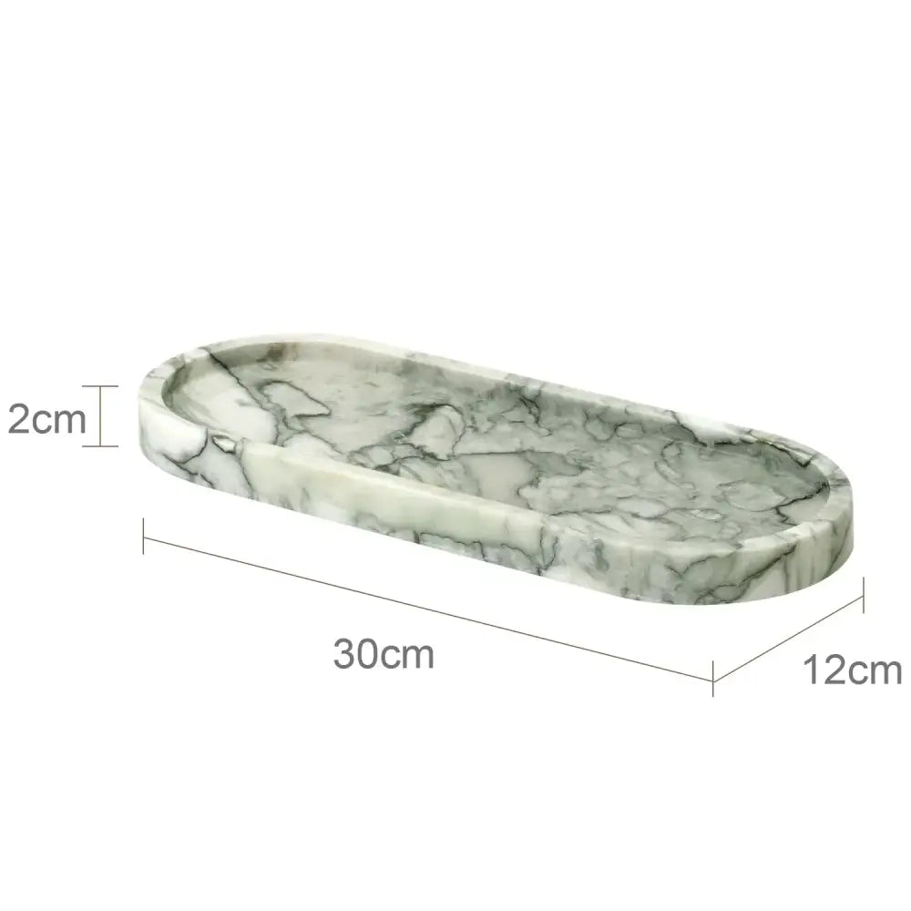 Oval-shaped marble tray with white and gold veining featuring emerald marble accents in luxury marble bathroom set