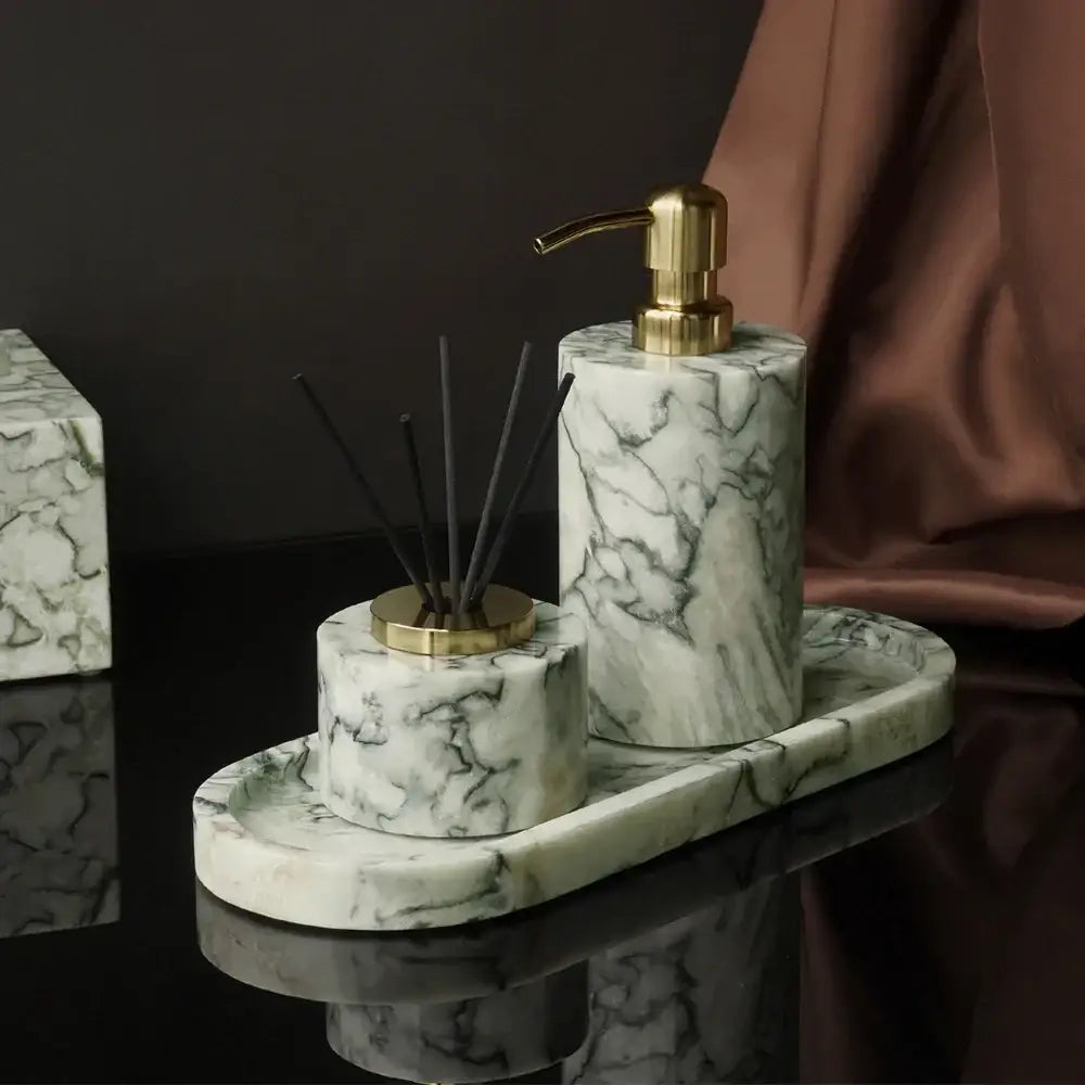 Luxury white and gold marble bathroom set with emerald marble accents featuring soap dispenser and reed diffuser holder on oval tray