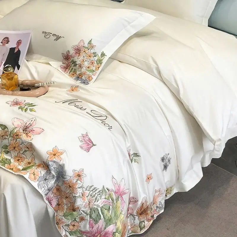 Luxury white satin bedding set with miss dior script and delicate cotton flowers embroidery in soft pinks and greens