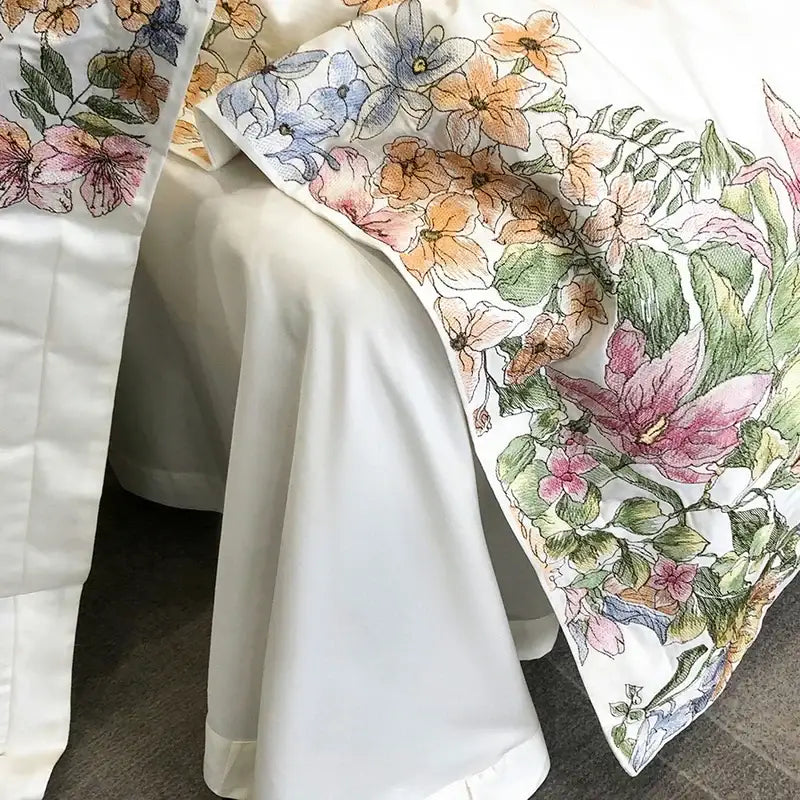 Luxury white egyptian cotton bedding set featuring vibrant cotton flowers embroidery in pink orange and blue tones