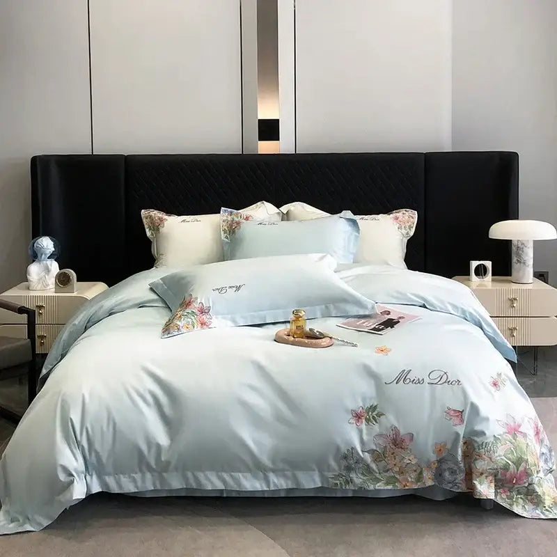Light blue satin bedding set with delicate cotton flowers embroidery and miss dior logo in luxury bedroom style