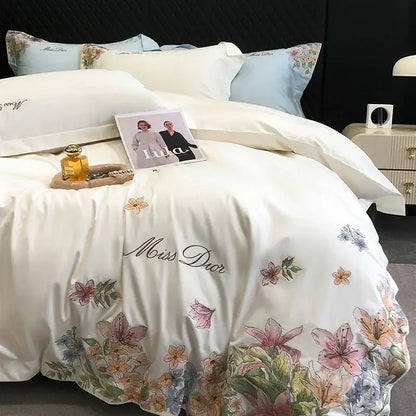 Luxury white miss dior bedspread with delicate cotton flowers embroidery in soft pink, peach and blue hues on egyptian cotton