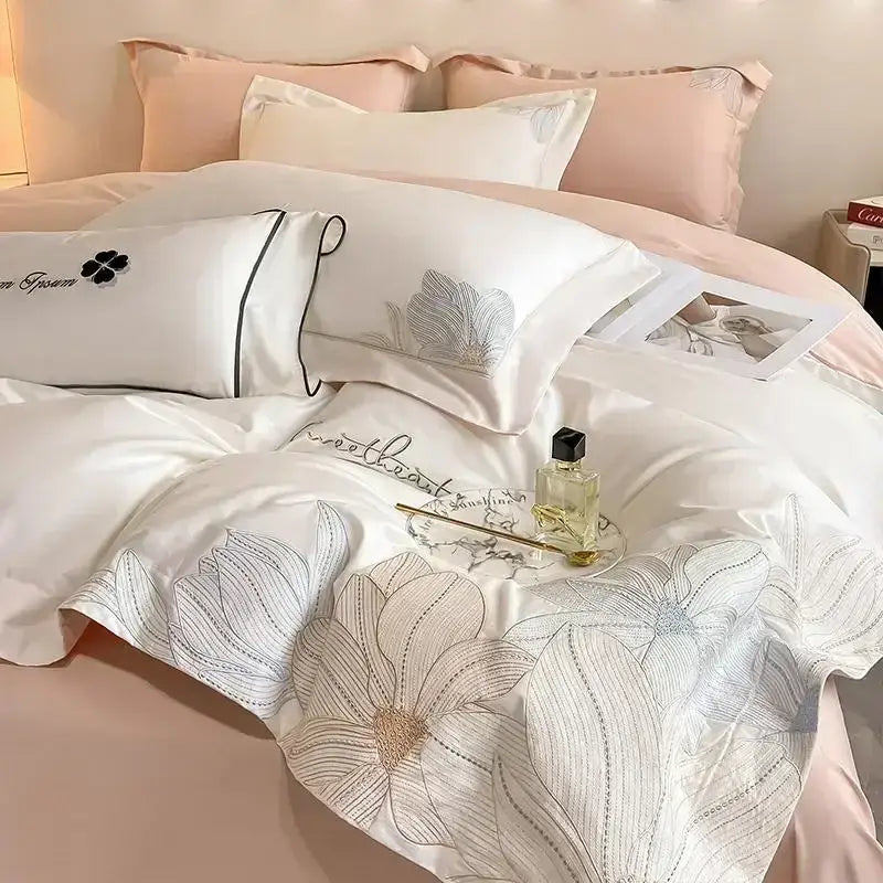 Luxury white and silver embroidered cotton bedding set featuring a satin duvet cover with delicate floral embroidery